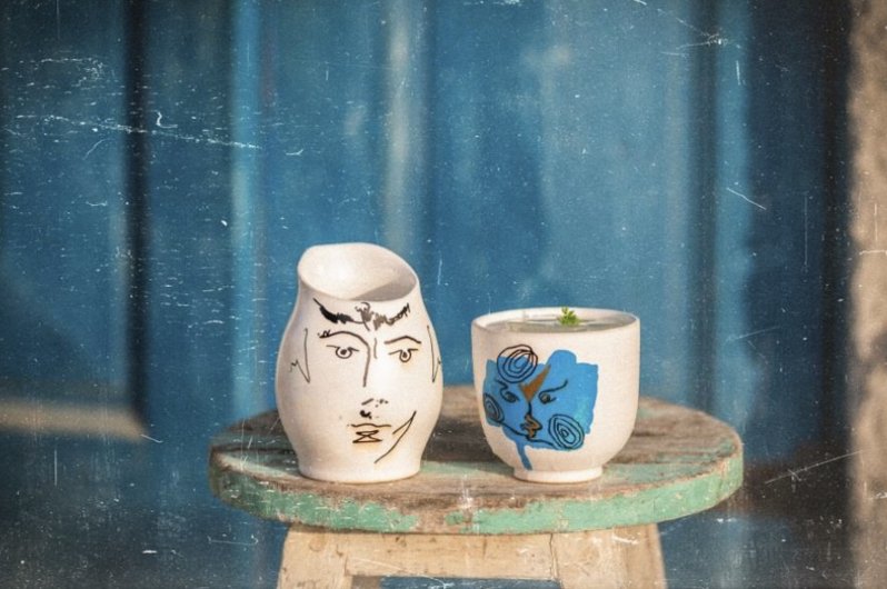 Two artistic ceramic vases on a stool